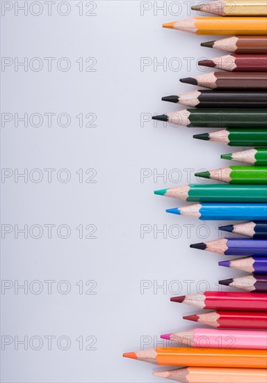 Color Pencils of Various colors placed on white background