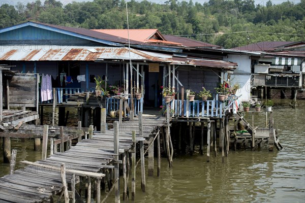 Walkway and huts on stilts in the river