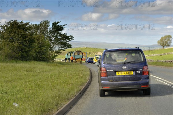 Traffic jam behind horse-drawn gypsy carts on the road to Appleby Fair