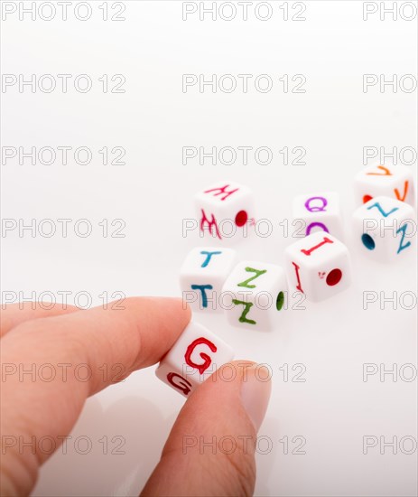 Colorful alphabet letter cubes in handon a white background