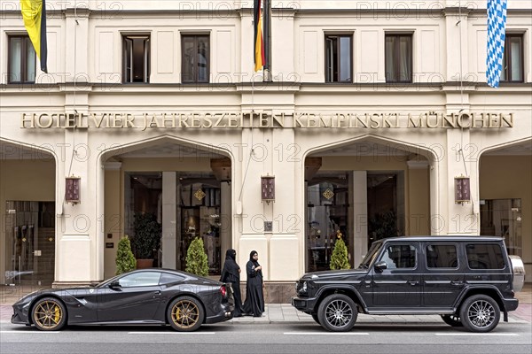 Parked sports car Ferrari F12 Berlinetta and SUV Mercedes-Benz AMG G 63