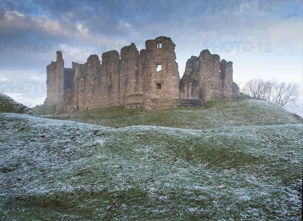 View of castle ruins at dawn in frost