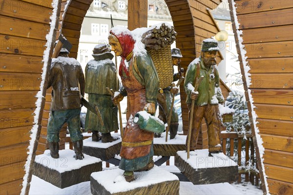 Carved wooden figures on the pyramid at the market place