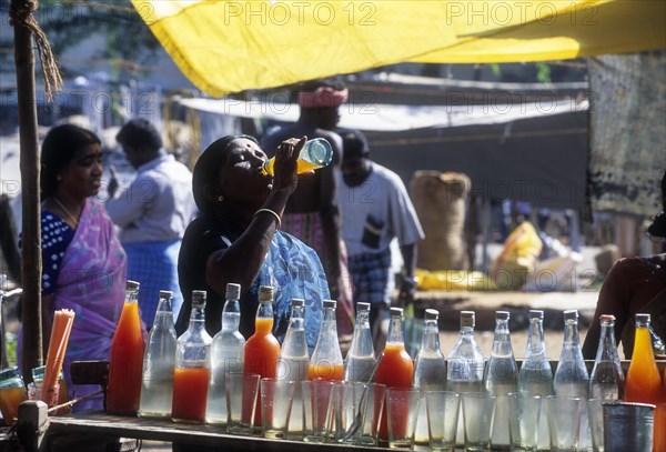 Village woman drinking syrup