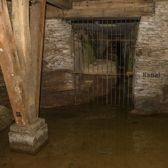 View of antker drainage canal in substructure Arenakeller cellar of historic Roman amphitheatre of Trier Treverorum Augusta with supports stamp of wood in groundwater
