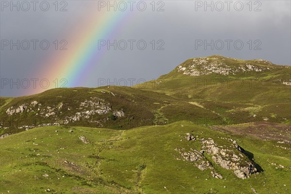 View of rainbow over mountains