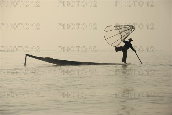 Traditional fisherman with fish trap in boat