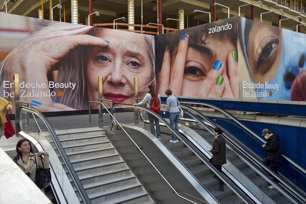 Large advertising posters on the stairs to the underground to hide the construction site behind