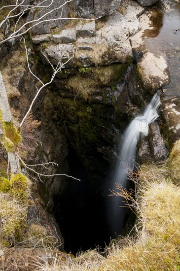 High mountain stream flowing into the abyss