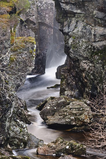 River and rocks near the waterfall at dusk