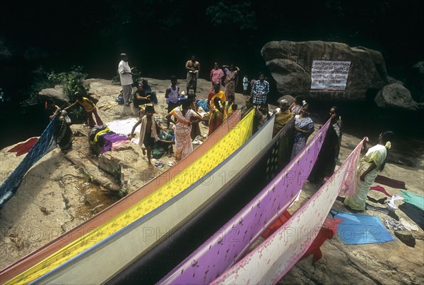 Women drying saris after bathing the Panchalingam falls at Thirumoorthy hills