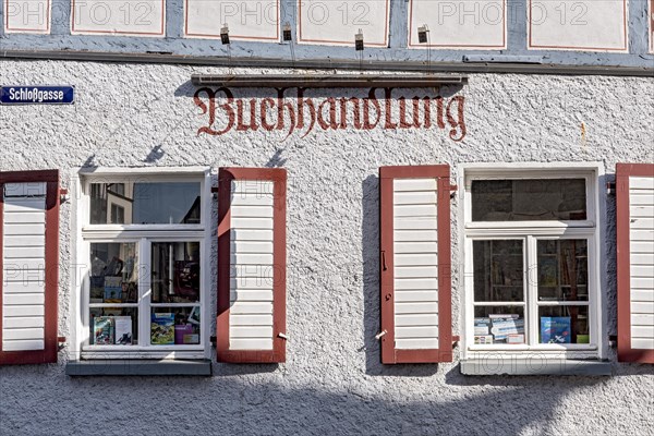 Historic house facade with windows and the inscription Buchhandlung in old German fracture script