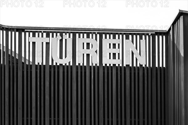 Lettering doors on wooden palisade