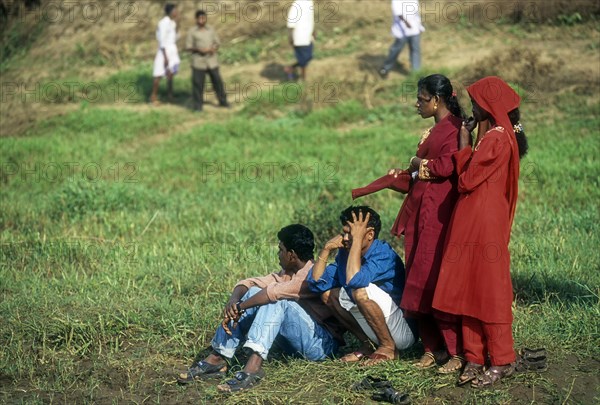 Spectators standing near the shore of Pamba River