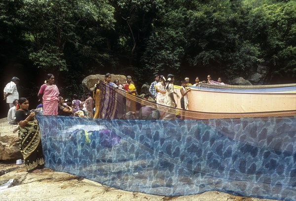 Women drying sarees after bathing River Cauvery