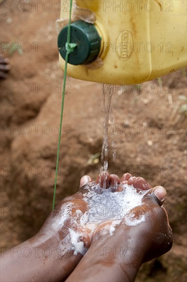 Washing hands under a homemade tap