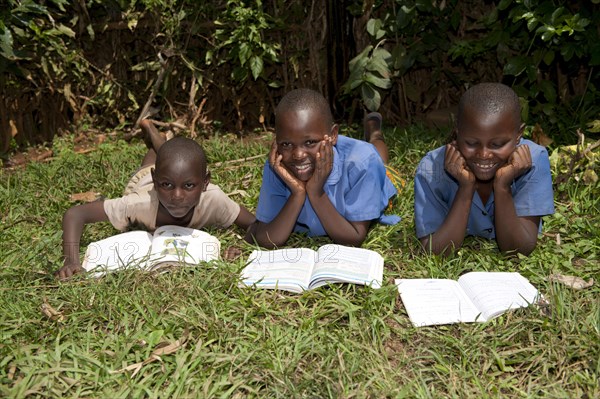 Smiling Rwandan children reading school books. Rwanda