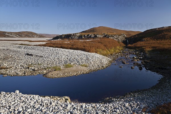 View of raised beach and waterfall near freshwater lochan