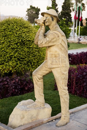 Sculpture of a photographing tourist