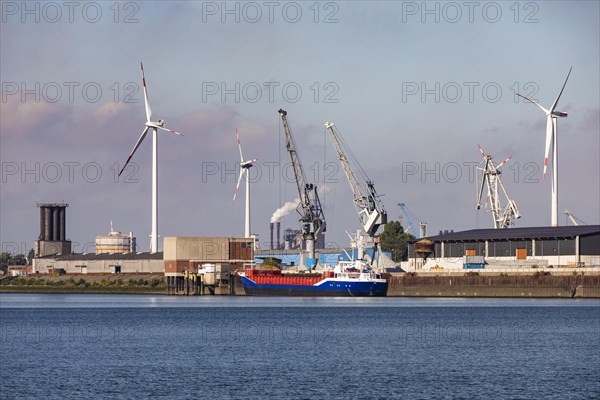 Cargo ship in front of a wind farm in the harbour
