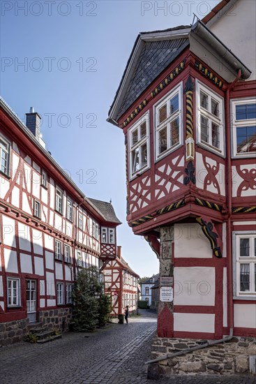 Medieval half-timbered houses with bay windows at the corner of the house