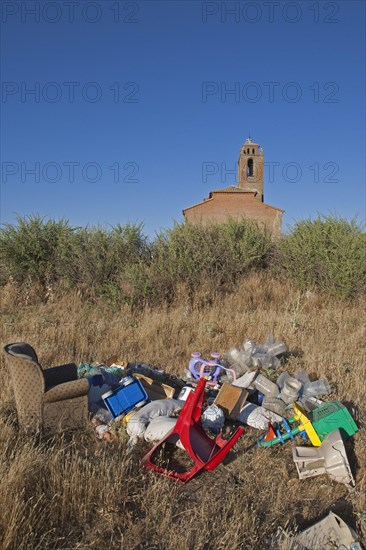 Flytipping of furniture and plastic rubbish in rural area