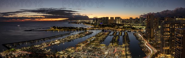 Dusk at the Ala Wai boat harbour with a view over Waikiki to Honolulu