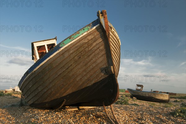 Abandoned fishing boats on shingle beach