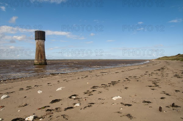 View of beach and former lighthouse converted to water-tower