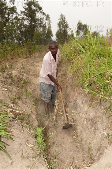 Farmers dig a ditch on the hillside to catch rainfall and prevent rapid soil erosion