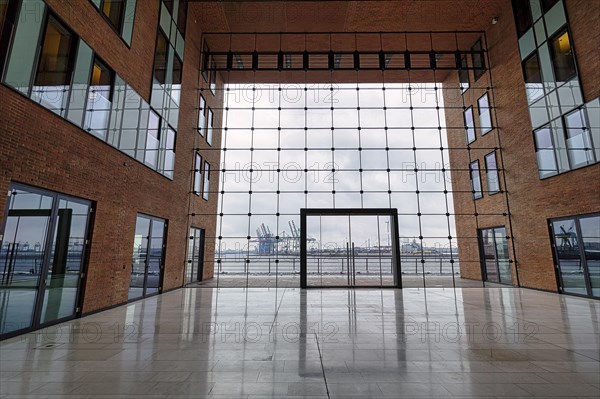 View through modern glass facade with large door onto the harbour