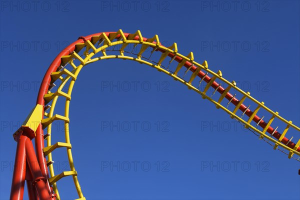 Roller coaster in front of blue sky