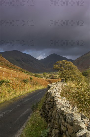 View of drystone wall at roadside in upland valley