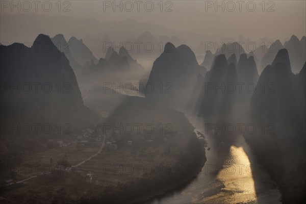 View of limestone karst formations along the river at sunrise