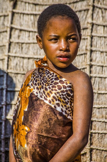 Children watch with interest at traditional customs in real African village