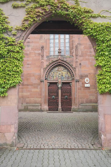 Archway with ivy to the St. Valentinus and Dionysius Basilica in Kiedrich