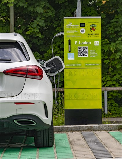 A Mercedes car with electric drive is charged at a charging station in Erding