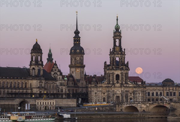 Full moon behind the silhouette of the old town with the towers of the Staendehaus