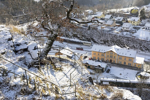 Terraced steep slope with vantage points from the outer castle of Wolkenstein Castle onto the historic railway station and Zschopau in the snow