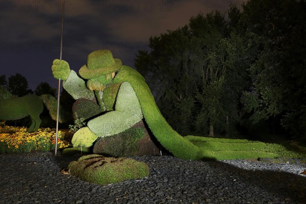 Light painting photography of a garden sculpture