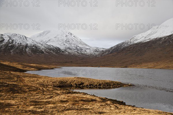 View across freshwater loch towards fishing hut