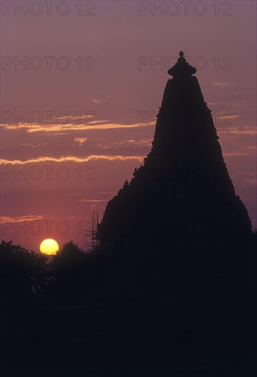 The Kandariya Mahadeva temple against glowing sun set in the Khajuraho