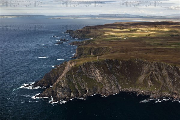Aerial view of coastline with cliffs and commemorative monument