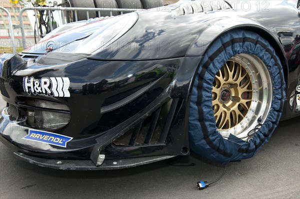 Porsche 911 racing car with tyre warmer in front of the start