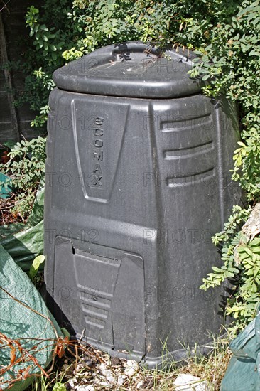 Plastic compost bin in garden