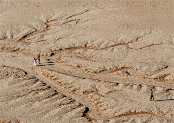 Three people in the desert