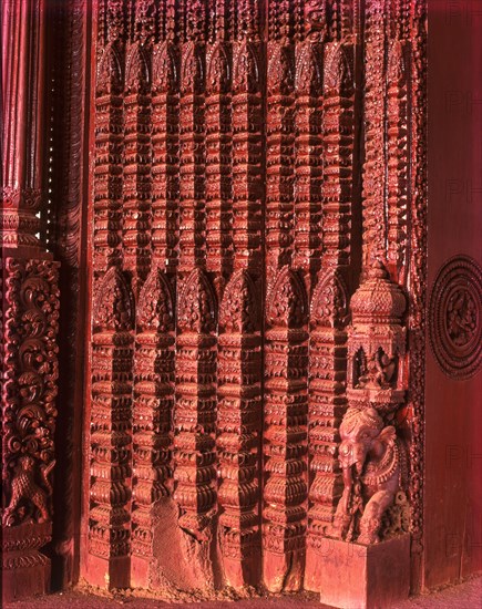 Richly carved wooden door of an old house portal in kanadukathan