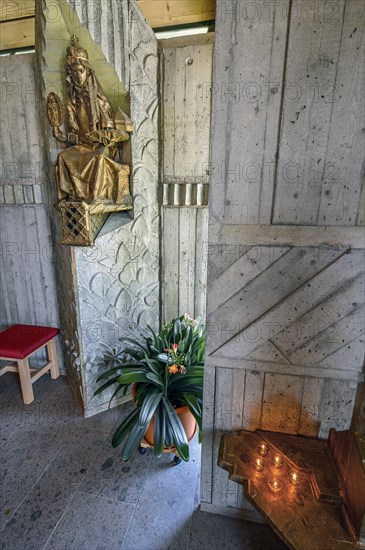 Figure of the saint with floral decoration and sacrificial candles