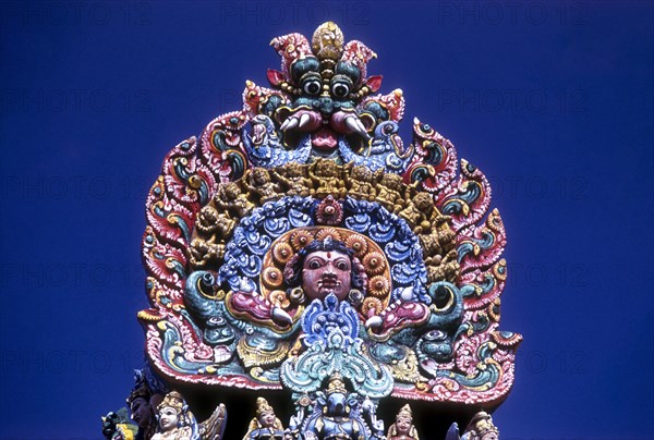 A temple carries this colourful sculpture of the fearsome kali