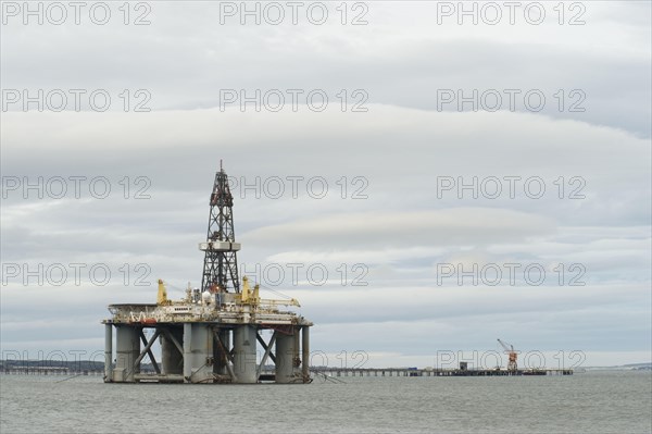 Oil rig moored in sea near coast